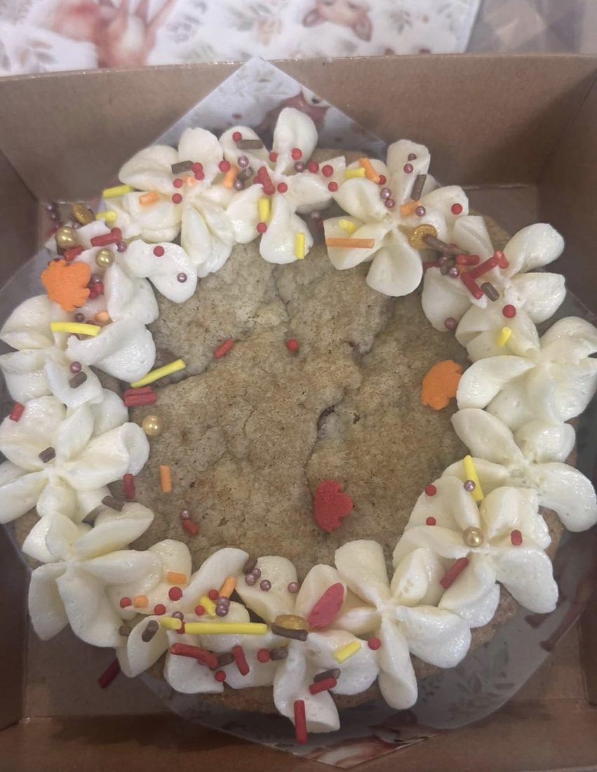 Sourdough mini chocolate chip cookie cake with white buttercream flowers and Fall sprinkles