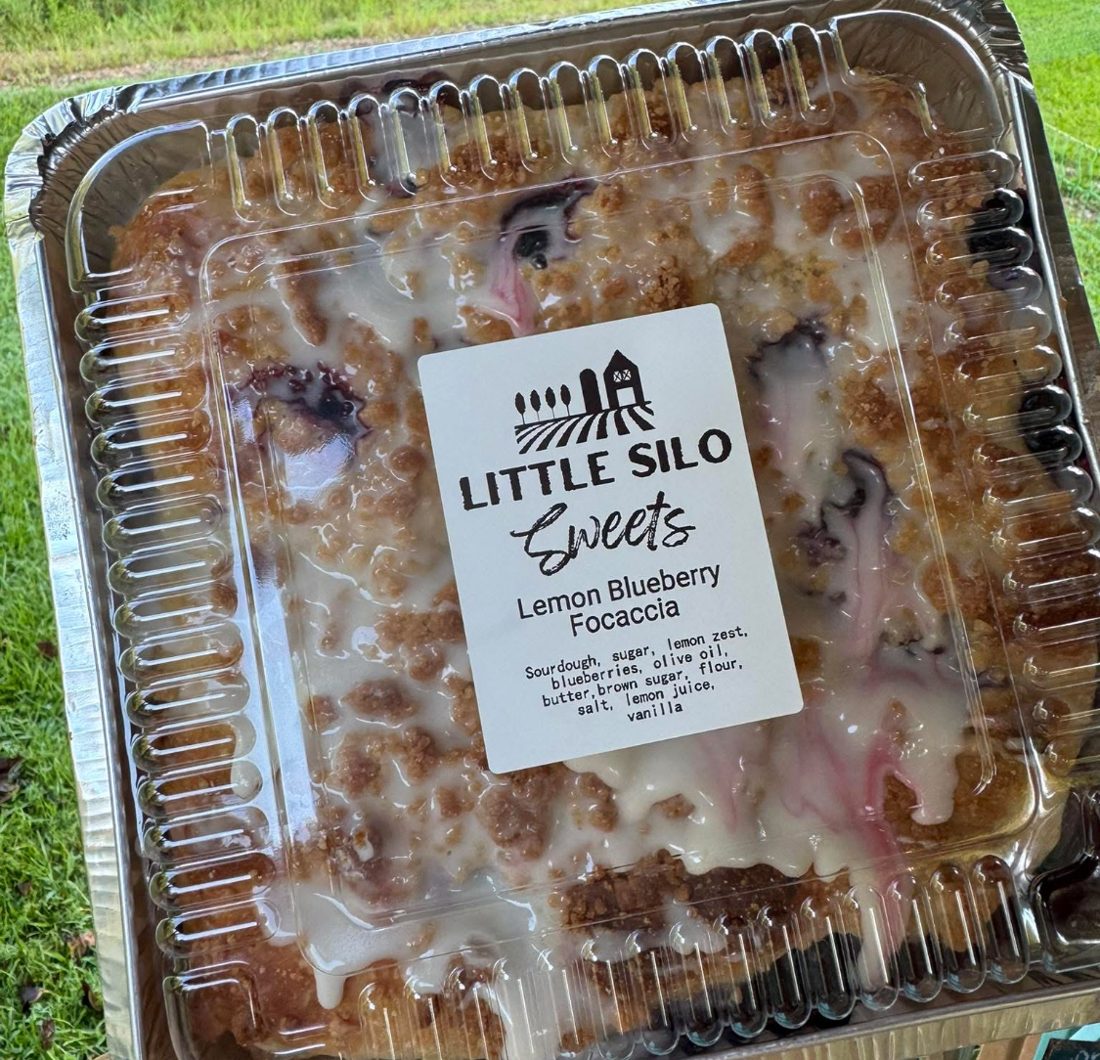 Lemon blueberry focaccia with crumb topping and glaze in a Little Silo Sweets container